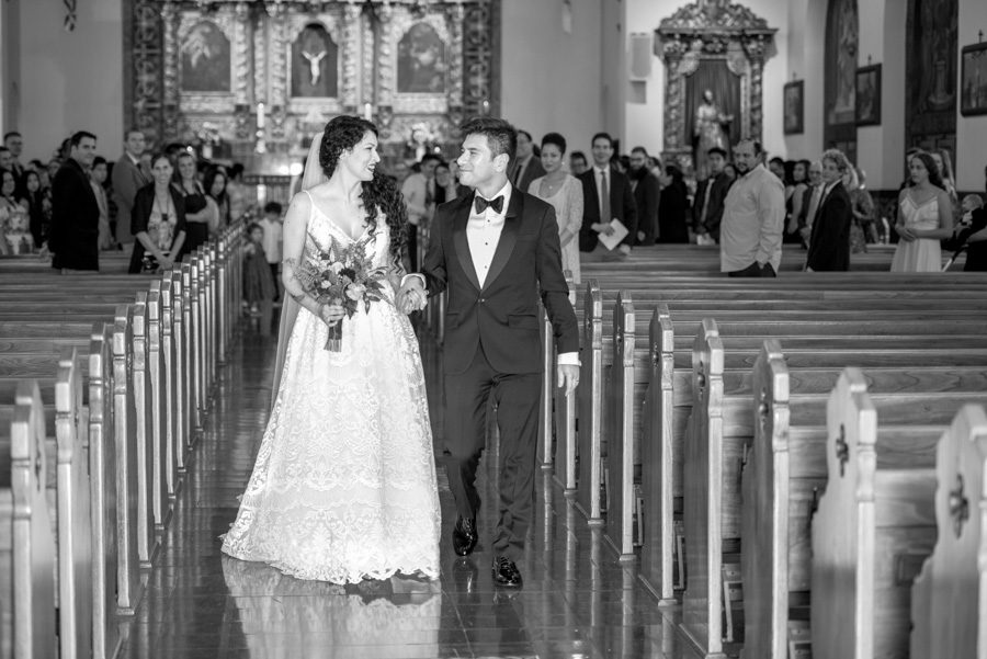 Bride and groom exit St Timothy's Catholic church