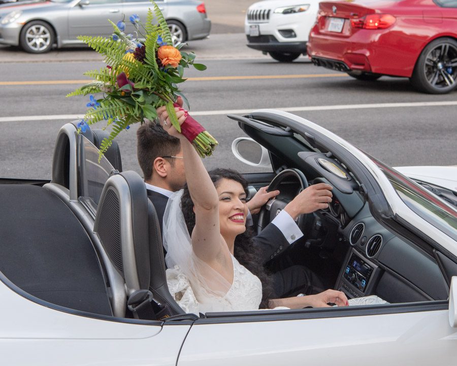 bride and groom in corvette leaving St Timothy's Catholic Church