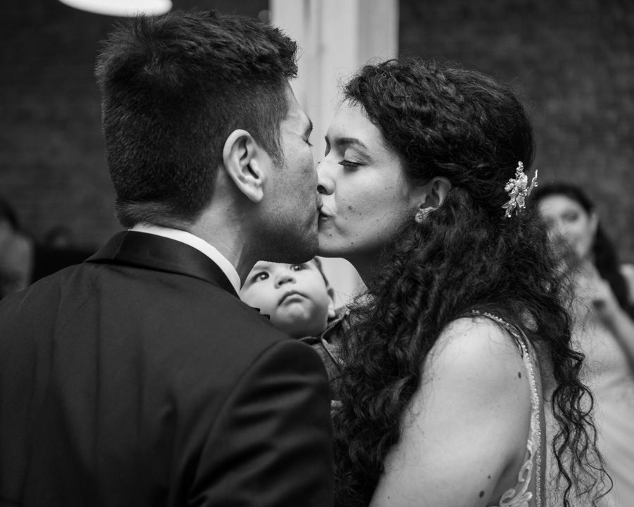 a kiss between bride and groom