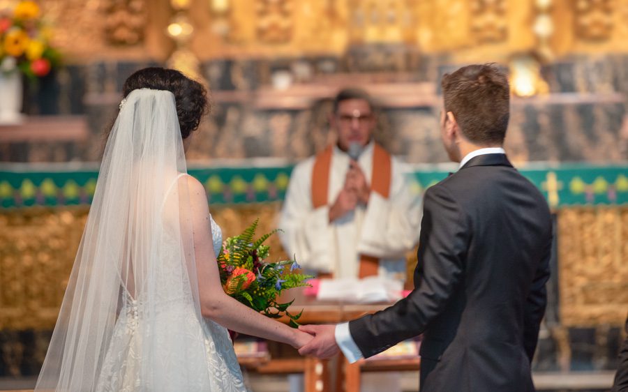 Bride and groom at the catholic church altar