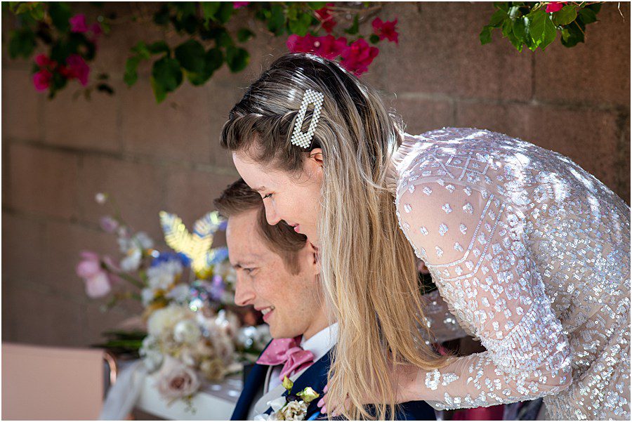 Bride checks out guests arriving for online wedding ceremony for a zoom wedding elopement