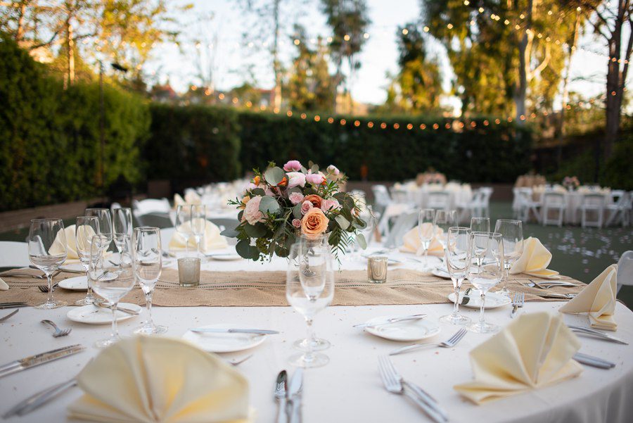 golden hour with beautiful rose table center piece at outdoor space beverly park west